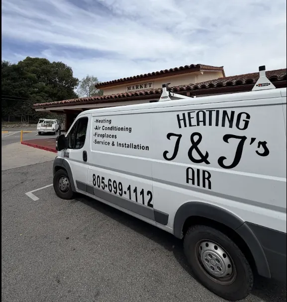 A white J and J Heating and Air van with the phone number 805-699-1112 on its side